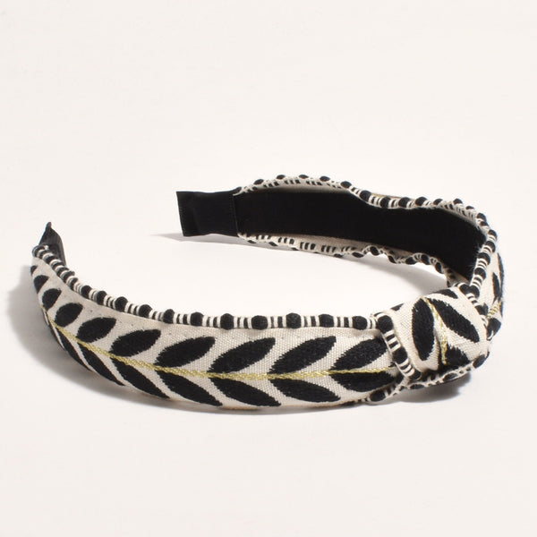 Leaf Pattern Headband in black and white with gold thread detail. The headband also has a knot accent on the top.