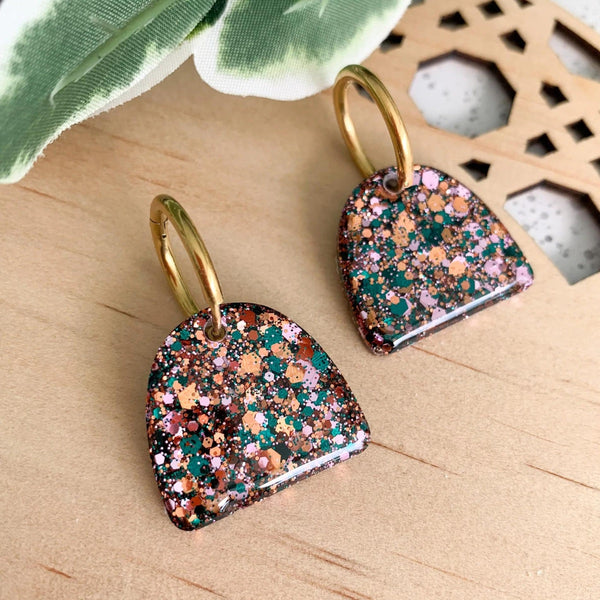 Arches Resin Earrings with green, gold and pink speckles. These earrings have a gold huggie closure