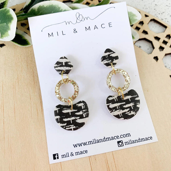 Basket Weave Clay Dangle Earrings in black and white with a gold resin circular drop