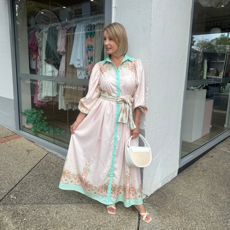 Our Kyleigh Floral Maxi Dress has a pale pink base and a gorgeous floral print on the hem, upper bodice and sleeves