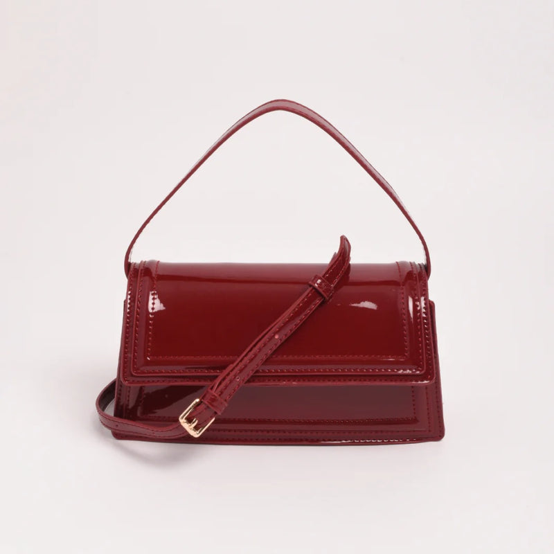 The bag has a detachable crossbody strap.