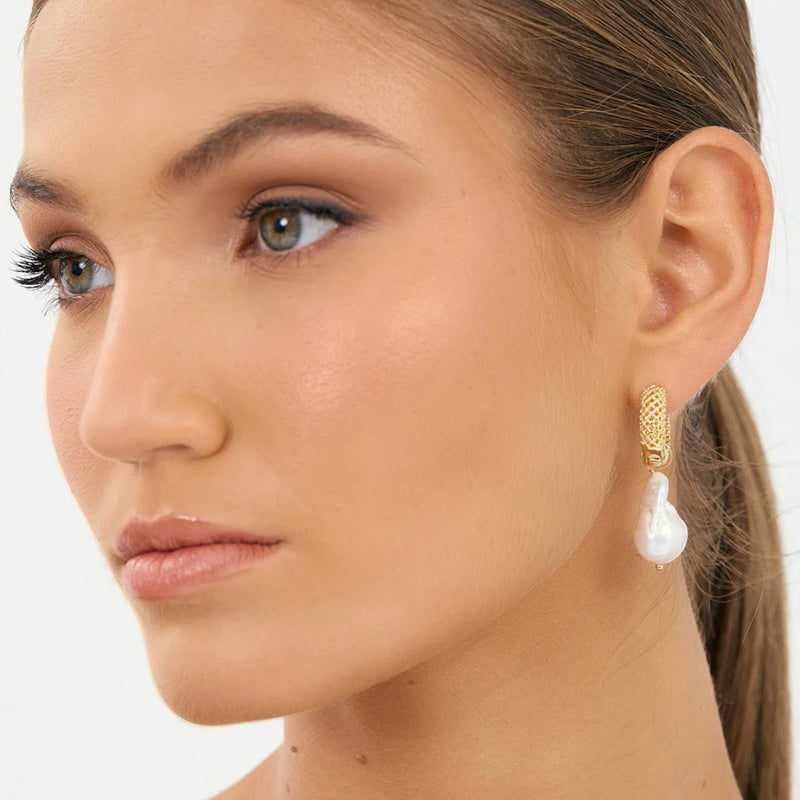 Model inspo pic - these earrings have a patterned hoop and a freshwater pearl drop.