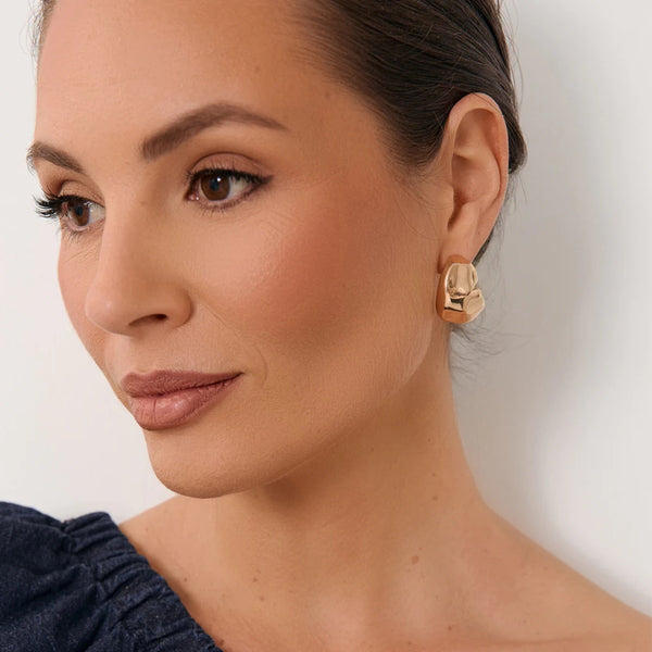 Model wearing these gold hoop earrings.