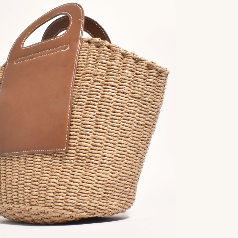 Close up of the woven bag with the vegan tan handles