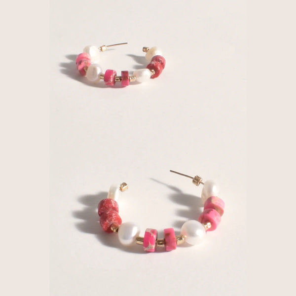 Our Boxy Stone & Pearl Mix Hoop Earrings are available in pink and white. They have a stud back closure.