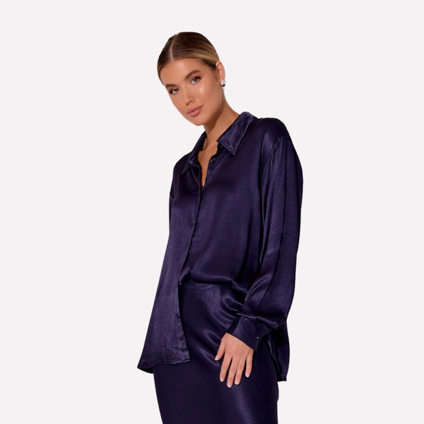 This satin shirt has a collar, button front and long sleeves with button cuffs