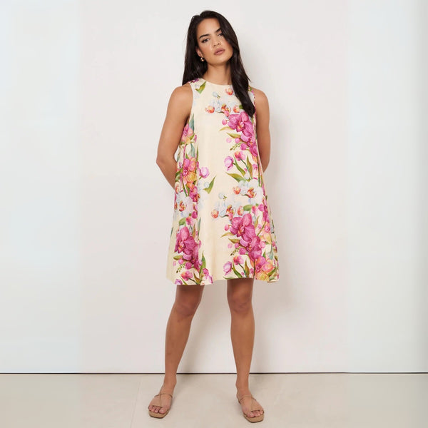 Our Cecelia Linen Dress has a colourful floral pink and green print with a cream base.