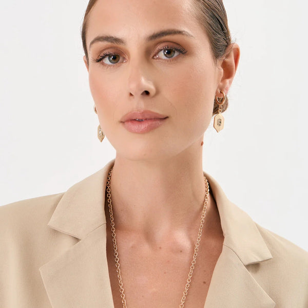 Model wearing our Charm Drop Crystal Earrings in Gold.