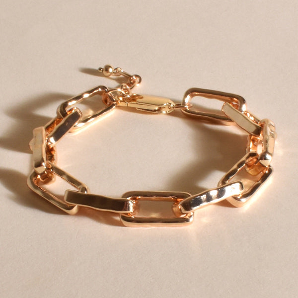 This chunky bracelet has gold rectangle links with a parrot clasp closure