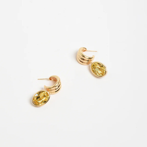 These gold semi hoop earrings have a yellow glass stone suspended from the hoop.