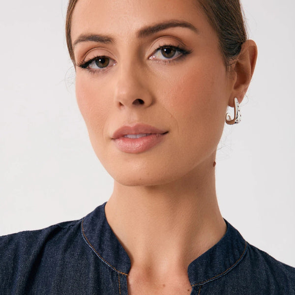 Model wearing our Diamante Set Curved Earrings in Silver.
