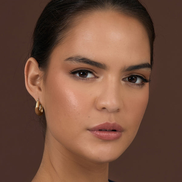 Model wearing the Enamel Dipped Metal Square Hoop Earrings in tan and gold.