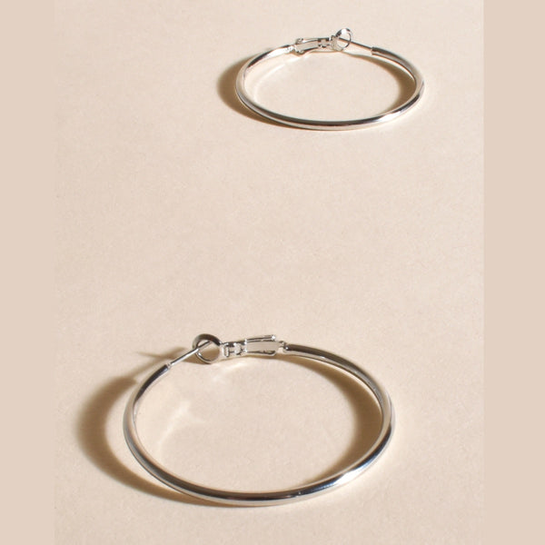 Essential Hoop Earrings in silver have a hinged closure and they're mid size