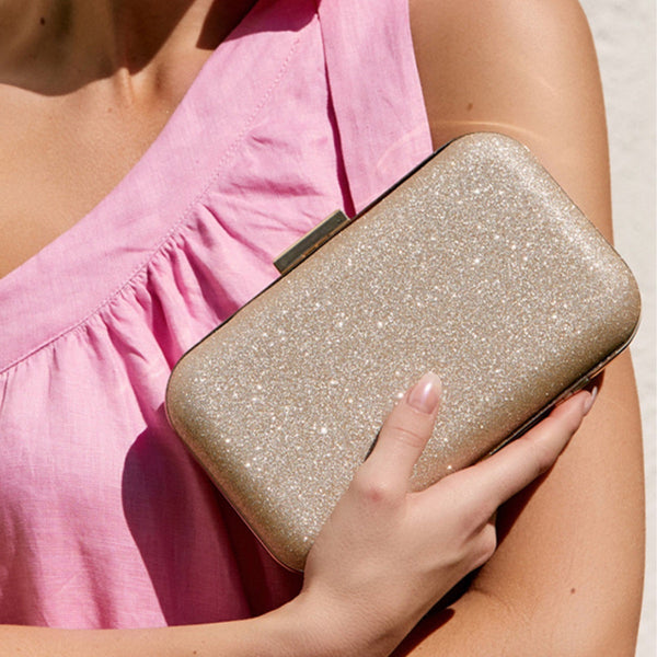 Everly Clip Bar Structured Rectangle Clutch in a gold shimmer