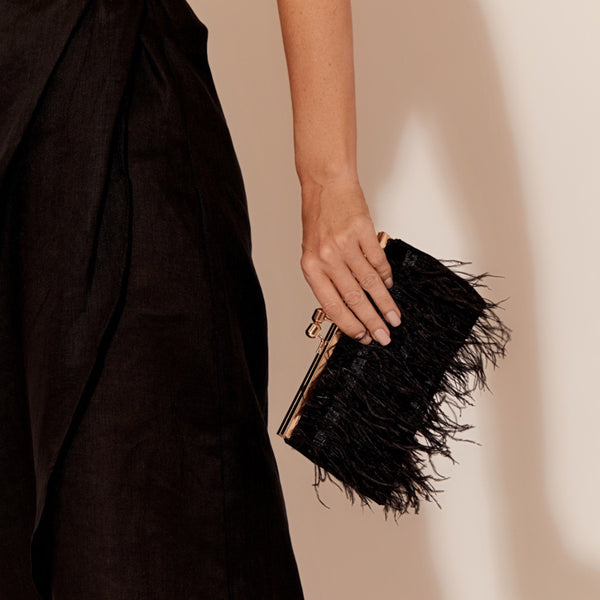 Feather Front Clutch with a black feather front and gold clasp closure