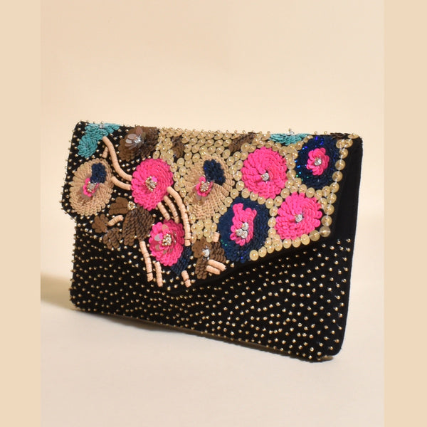 Floral Sequin Fold Over Clutch has pink, blue and teal sequin flowers on the front