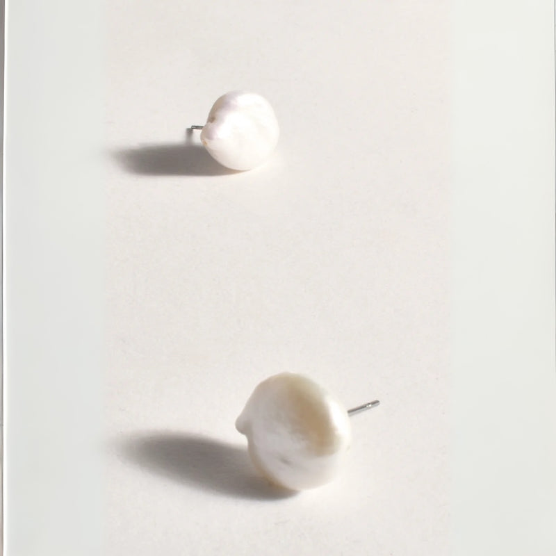 These stud earrings have a freshwater pearl in a button shape.
