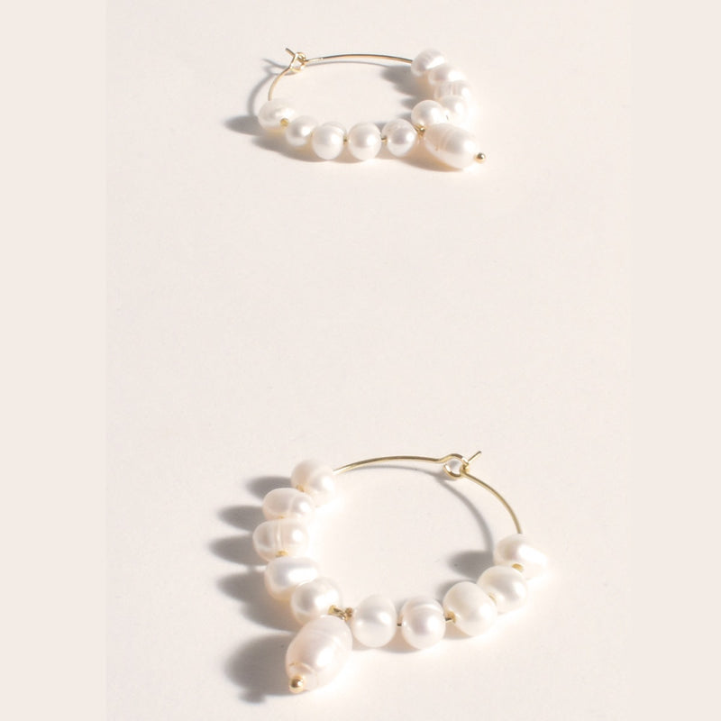 These gorgeous pearl hoop earrings also have a small pearl suspended from the hoop