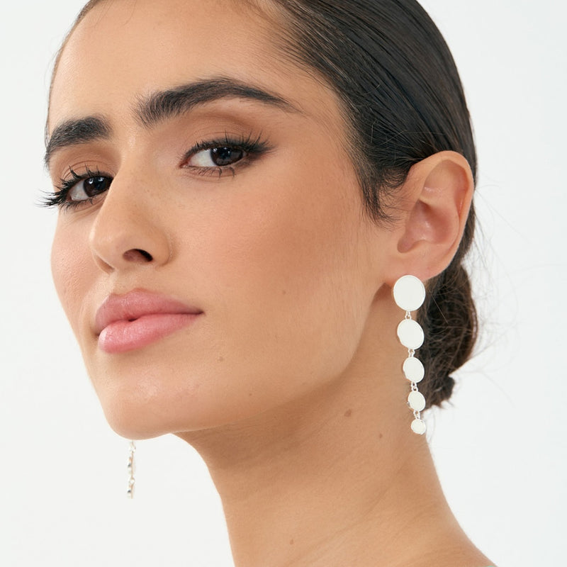 Model pic for inspo - wearing the silver version. These earrings have a stud back closure and graduated shell drops.