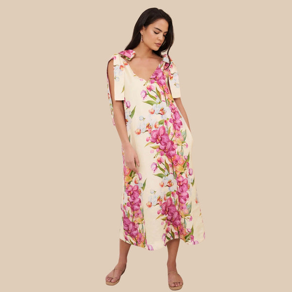 Our Hallie Tie Shoulder Dress has an exclusive floral print against a cream base.