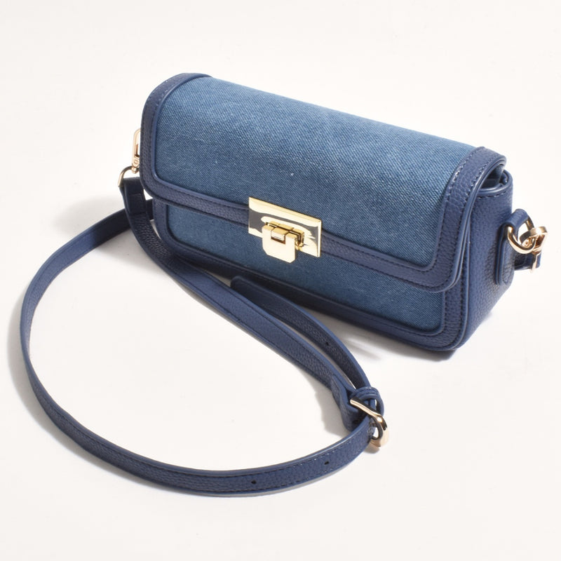 This blue hand bag has a fold over flap, gold hardware.