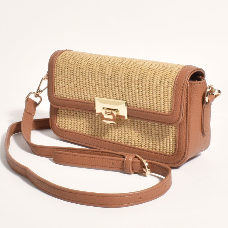 This compact tan bag will fit all your essentials and has a fold over flap with clasp closure