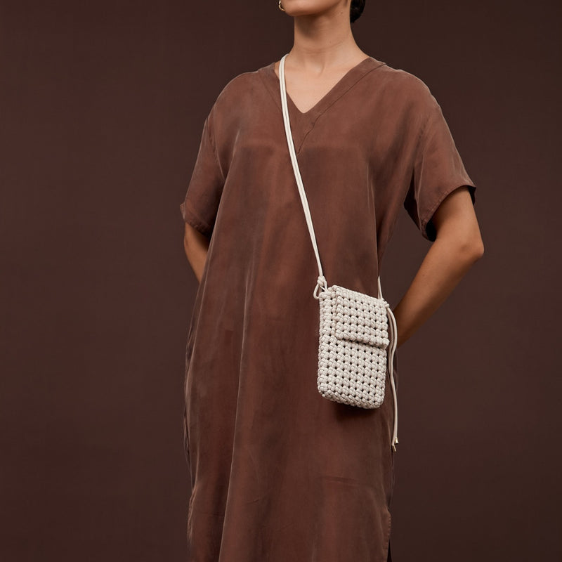 Model wearing the Imogen Weave Mini Crossbody Bag in white