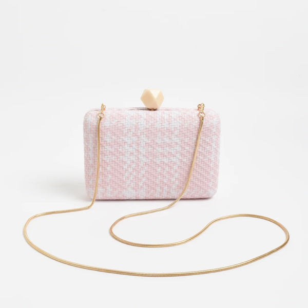 Our Janey Faux Weave Structured Clutch in pink and white. Features a gold snake chain shoulder strap and a cream coloured resin clasp closure.
