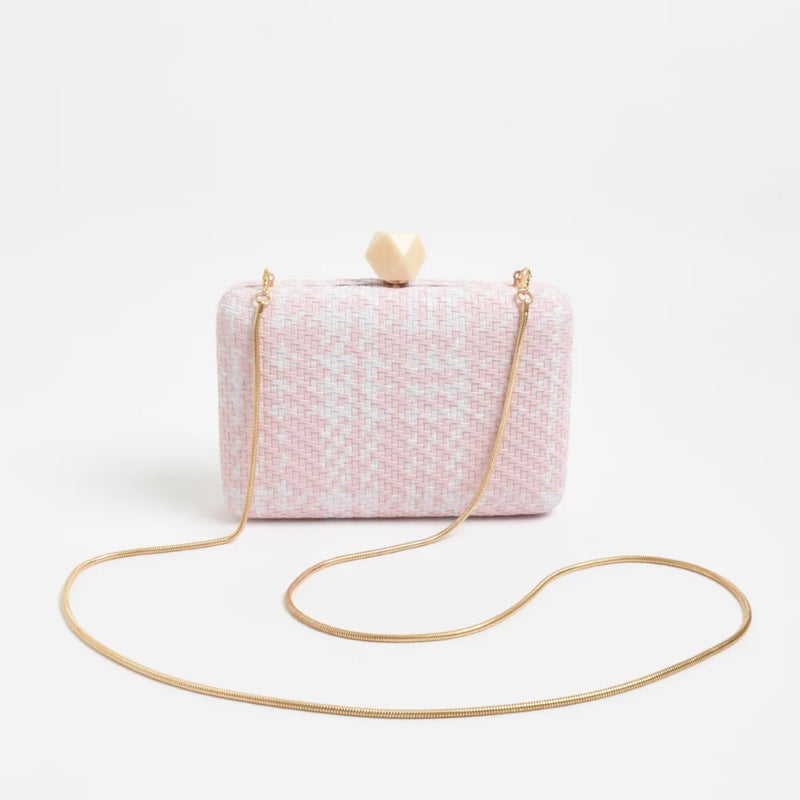 Our Janey Faux Weave Structured Clutch in pink and white. Features a gold snake chain shoulder strap and a cream coloured resin clasp closure.
