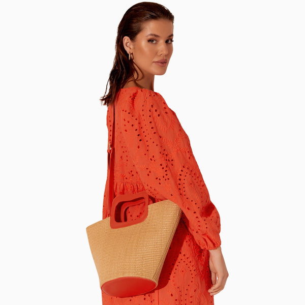 Juni Woven Basket Bag has a detachable tangerine shoulder strap