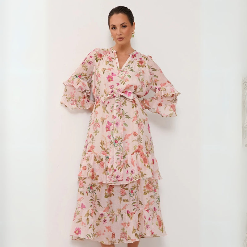 Features a mock collar, V cut-out, frill accents on the sleeve and it has a frill skirt.