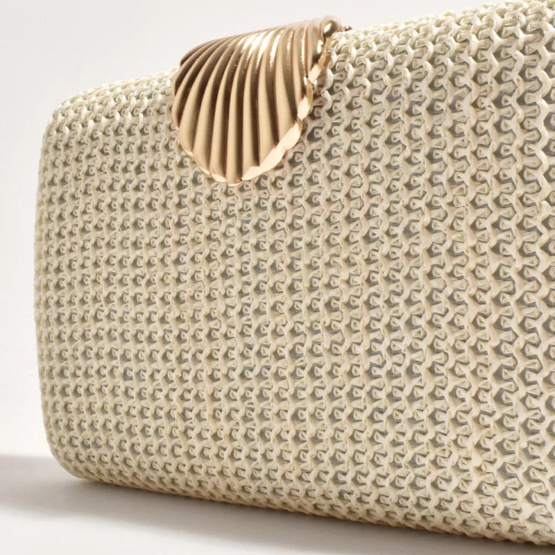 Close up of the cream woven fabric and the gold metal clasp