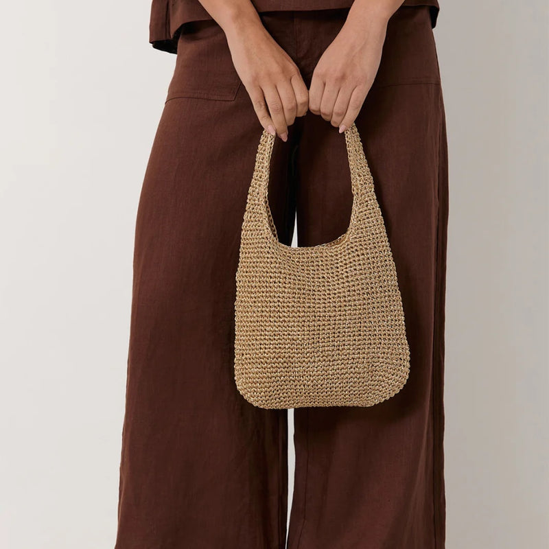 The bag has a single top handle and is the perfect size to fit your essentials.
