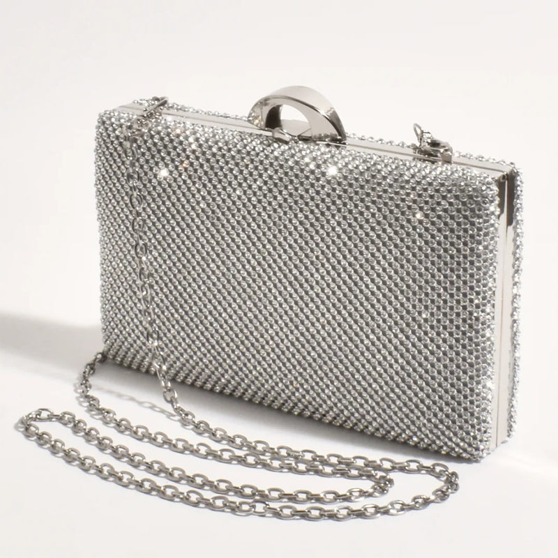 This structured rectangle clutch has silver diamantes and a detachable silver chain shoulder strap.