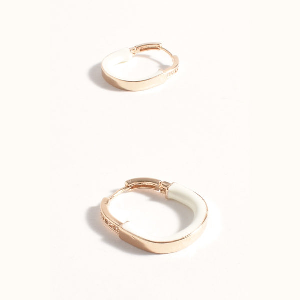 Mini Enamel Metal Hoop Earrings in Gold and White. They have a diamante detail on the upper front.