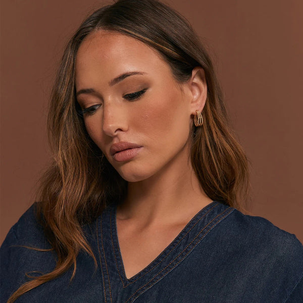 Model wearing our Mini Trio Metal Ball Hoop Earrings in gold.