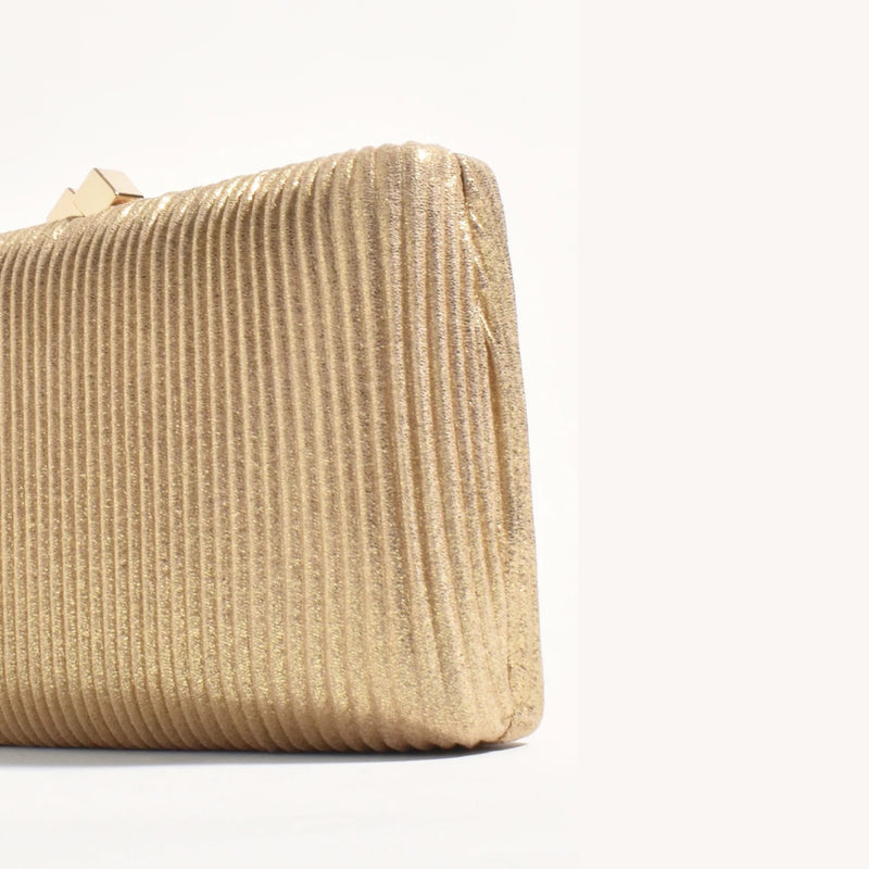 Close up of the gold textured ribbed metallic fabric.