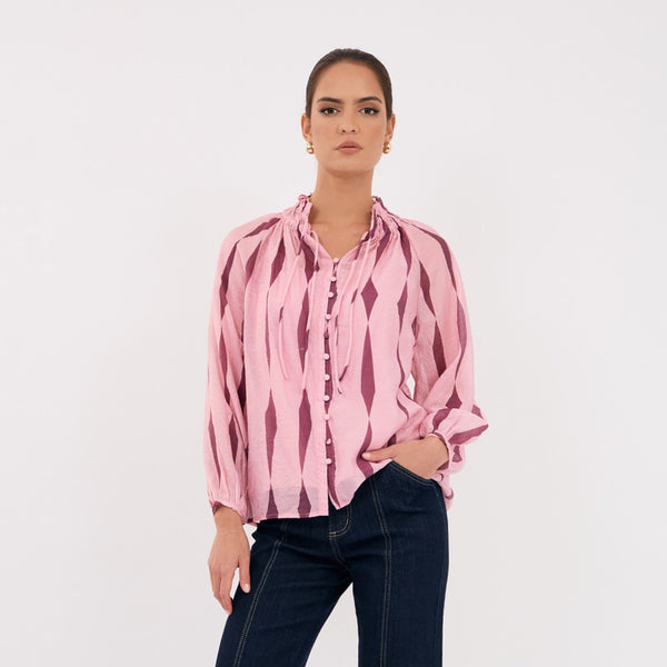 The top has a shirred mandarin neckline, long sleeves, button front and it includes a separate pink cami.