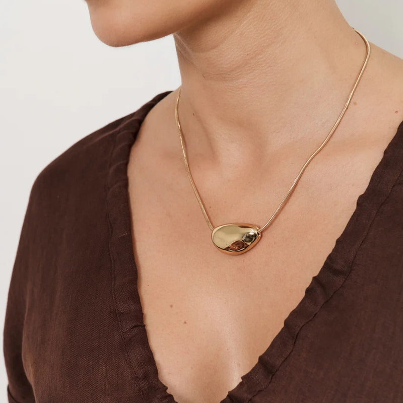 Model wearing our Pod Centre Fine Snake Necklace in gold.