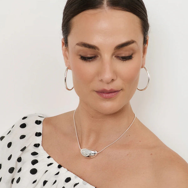 Model wearing our Pod Centre Fine Snake Necklace in silver.