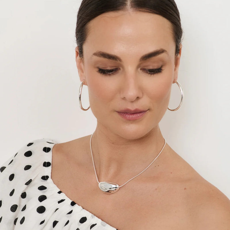 Model wearing our Pod Centre Fine Snake Necklace in silver.