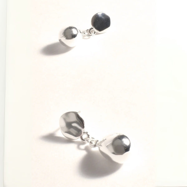 Our Pod Drop Earrings in silver. They have a stud closure.