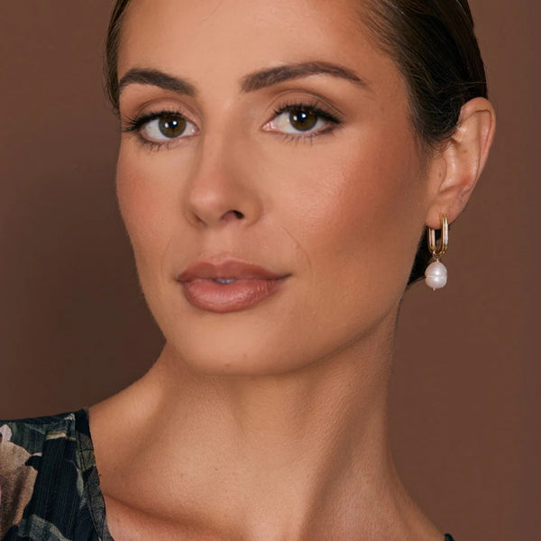 Model wearing the Rectangle Link Pearl Drop Earrings in gold.