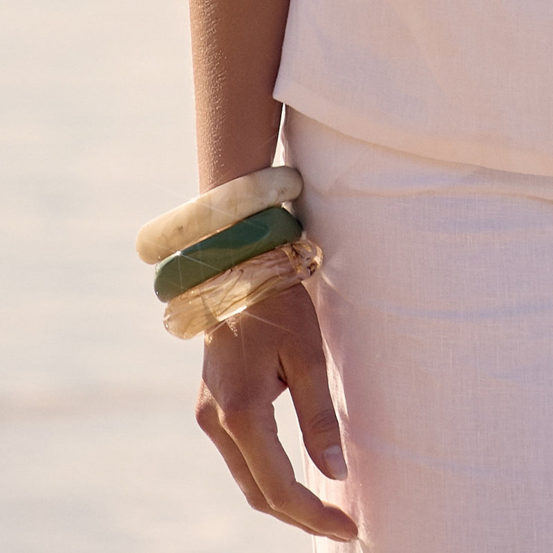 Model wearing the resin bangles stacked in various colours.