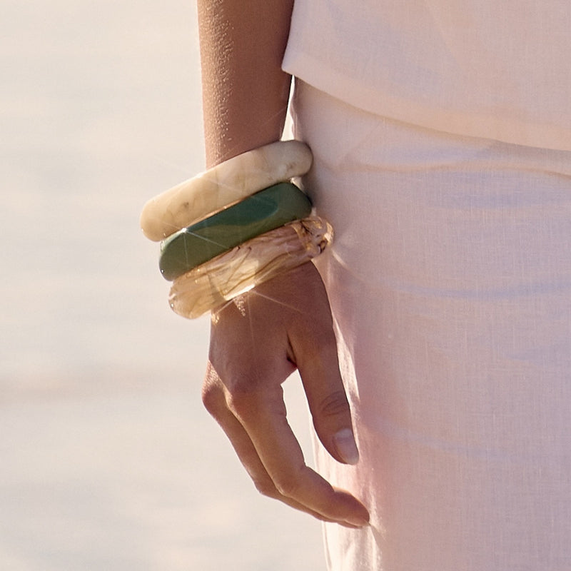 Model wearing the resin bangles in various colours stacked on her wrist.