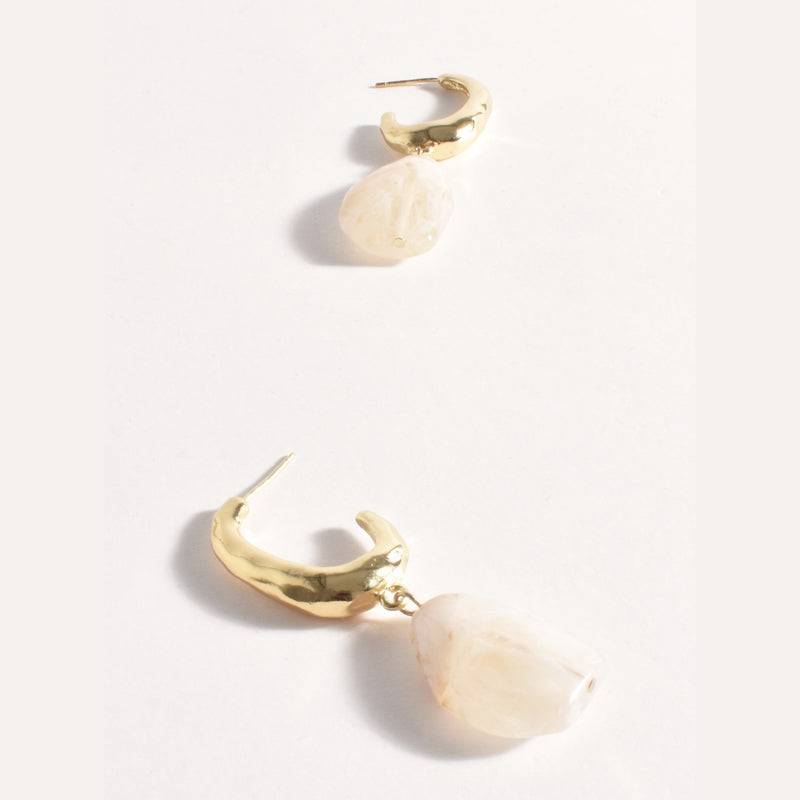 Resin Drop Textured Hoop Earrings in cream and gold. They have a stud back closure.