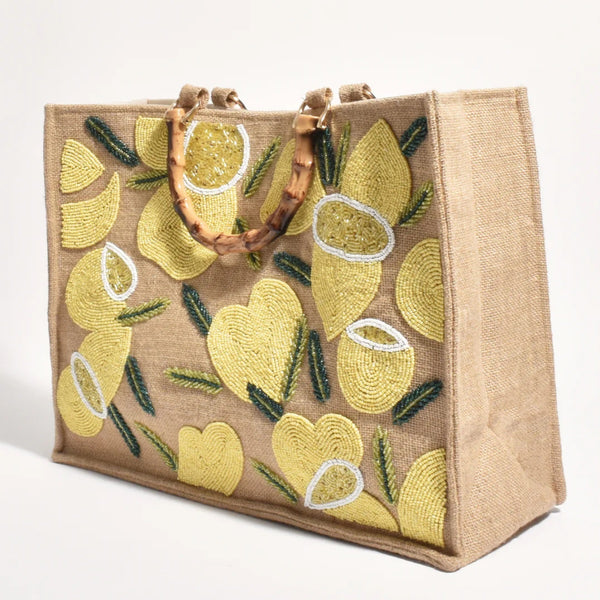 This stunning tote bag has a beaded lemon detailing on the front and faux bamboo top handles