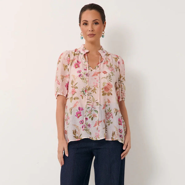 This gorgeous top has a ruffle neckline, V cut-out with neck ties, short sleeves and a loose fit body.
