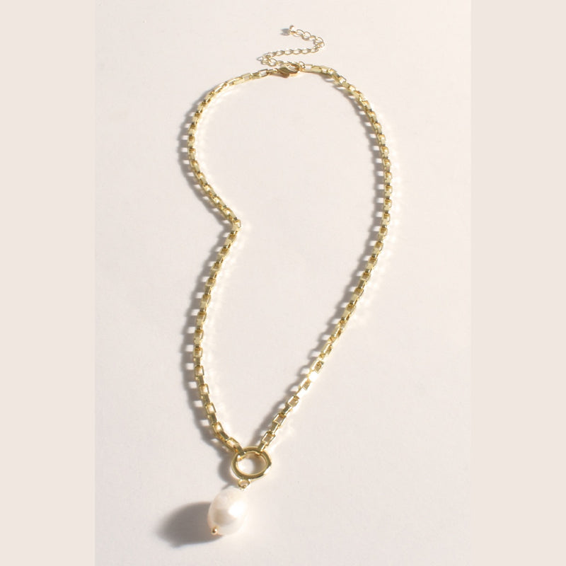 This necklace is adjustable and has a freshwater pearl suspended from a circular link