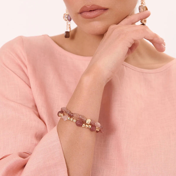 Model wearing the Stone Metal Mix Stretch Bracelet Set in pink.